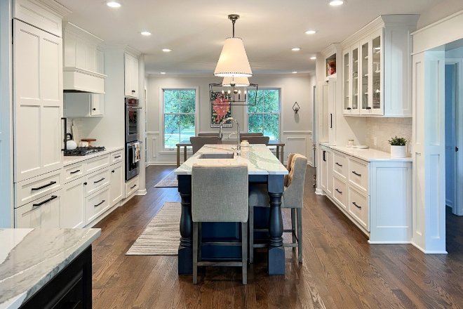 Large-open-concept-white-kitchen-with-island-and-pendant-lights