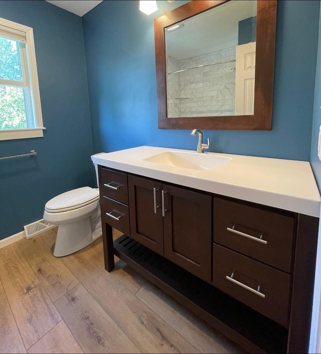 dark-wood-bathroom-vanity-white-countertop-toilet