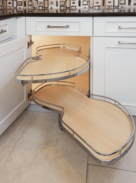 Screenshot 2026-09-24 140026 Curved pull-out pantry shelves extending from lower kitchen cabinet, forming a zigzag, wooden-textured surfaces with metal rails.